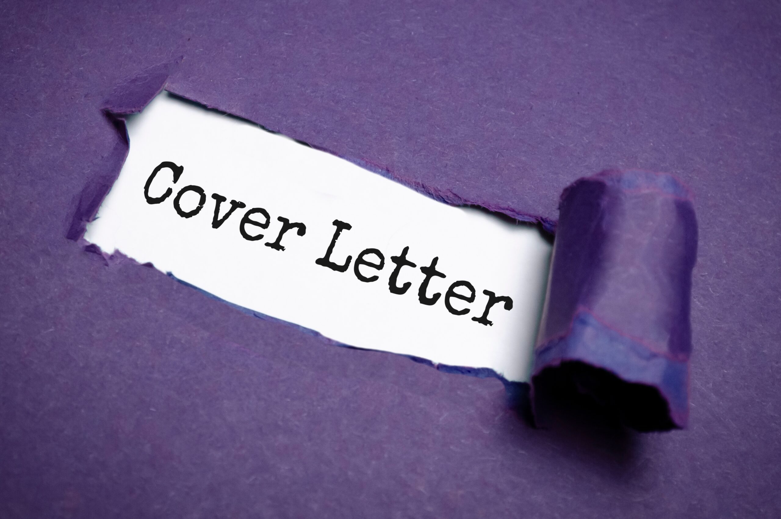 A close-up image of purple paper being torn open to reveal the words “Cover Letter” printed in black on a white background.