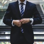 Man adjusting suit, preparing for interview