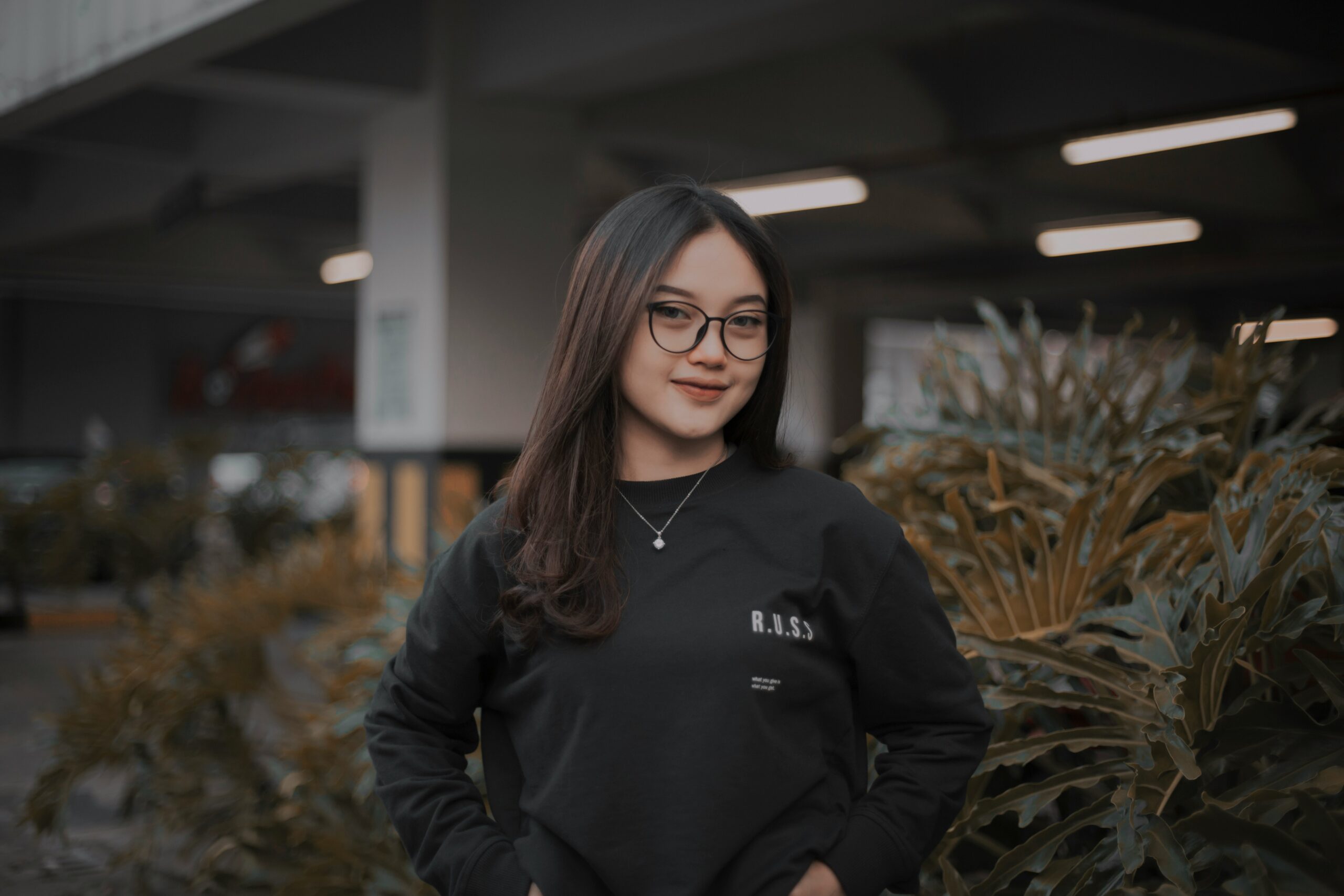 A young woman confidently posing outdoors, representing career development and internship opportunities.